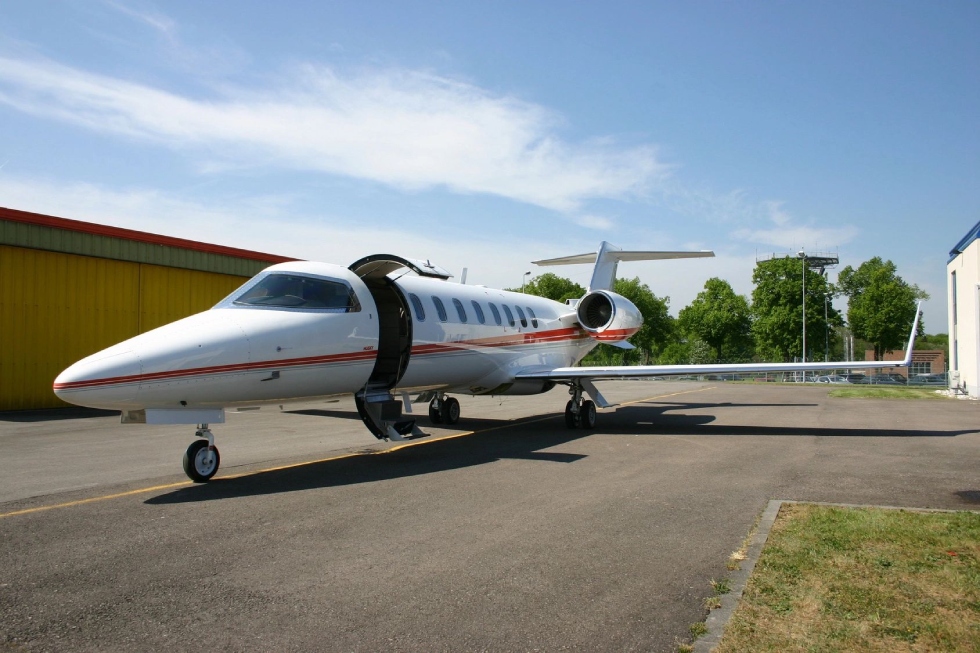 A small white airplane sitting on top of an airport runway.